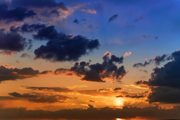 Sommersonnenuntergang Gewitterwolken auf dem Hintergrund des orangefarbenen Himmels