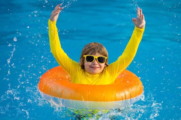 Sommerspaß, kleines Kind schwimmt im Pool. Kind im Schwimmbad. Kind entspannt sich beim Schwimmen auf einem aufblasbaren Ring