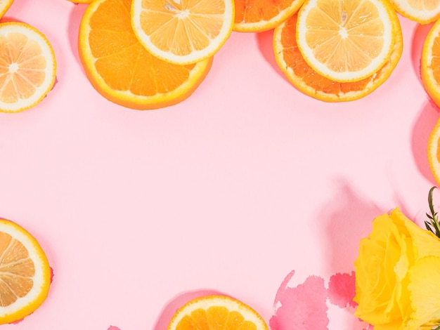 Sommerstimmung orange Zitrusscheibe Fruchttextur Hintergrund auf Pastellrosa mit nassen Stellen