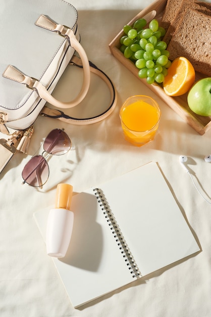 Sommerurlaub mit Tasche, Obst, Sonnencreme, Brille, Zubehör auf weißem Hintergrund