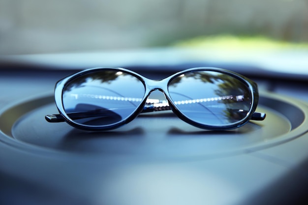 Foto sonnenbrille auf der autotafel in der nähe
