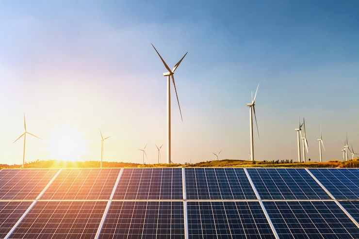Foto sonnenkollektoren und windkraftanlage mit sonnenuntergang auf dem hügel. konzept idee saubere energie