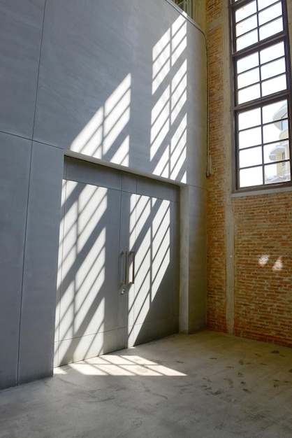Sonnenlicht vom Fenster auf die Zementwände und den Boden im Inneren des alten Gebäudes