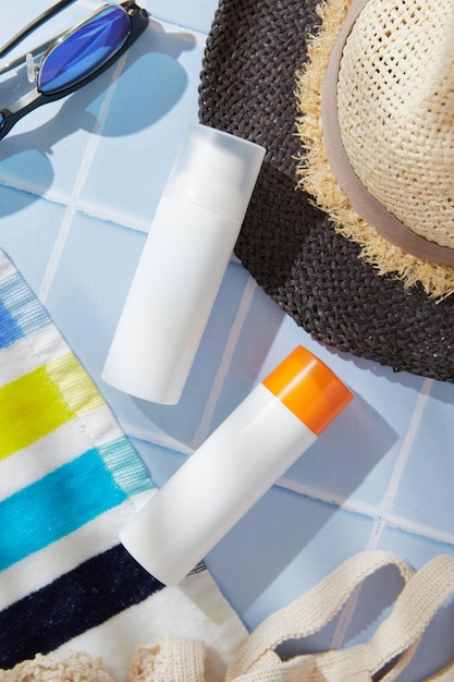 Sonnenschutzlotion auf blauem Hintergrund Pflegeprodukte Sommer-Strand-Accessoires Körperpflege-Schönheitsbehandlung