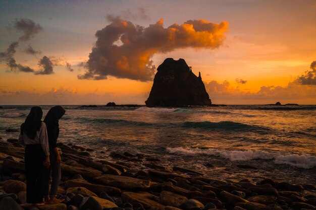 Foto sonnenuntergang am felsigen strand in papuma jember ost-java indonesien