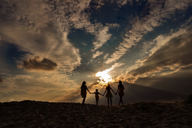 Sonnenuntergang und Familiensilhouette mit Sonnenuntergang im Hintergrund