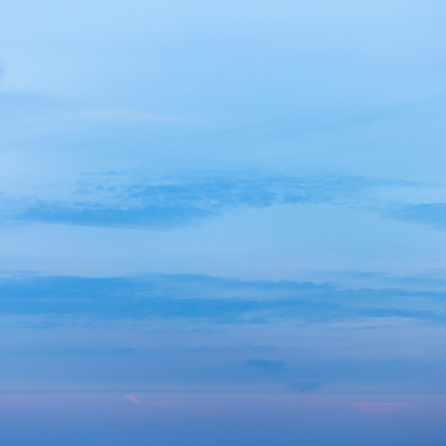 Sonnenuntergangwolken im dunkelblauen Himmel