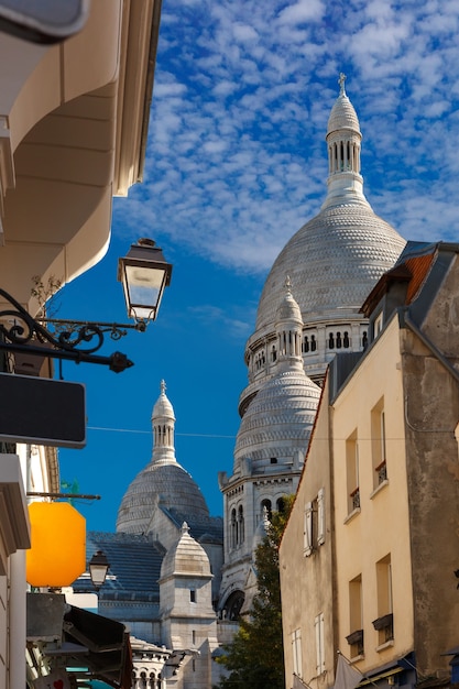 Sonnige Straße und die Kuppeln von Sacre-Coeur am Morgen, Viertel Montmartre in Paris, Frankreich