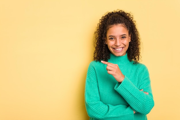 Sonriendo alegremente apuntando con el dedo índice lejos