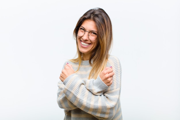 sonriendo alegremente y celebrando, con los puños cerrados y los brazos cruzados, sintiéndose feliz y positivo