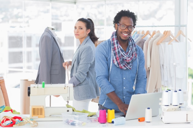 Sonriente equipo de diseñadores de moda