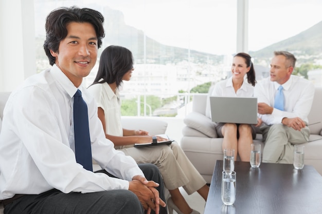 Sonriente hombre de negocios con compañeros de trabajo