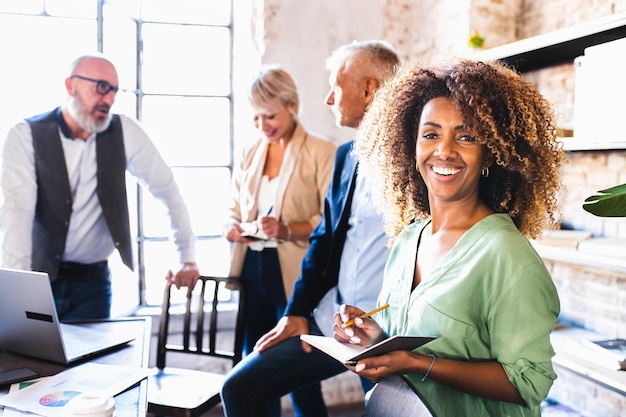 Sonriente mujer de negocios en el trabajo de liderazgo y concepto de trabajo en equipo retrato de un empleado gerente o trabajador de un equipo creativo