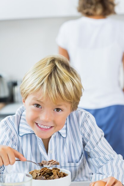 Sonriente niño desayunando