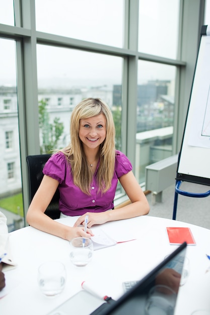 Sonriente rubia empresaria trabajando en la oficina