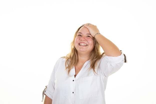 Sonriente rubia feliz mujer de gran tamaño mano dedo en el cabello en estudio disparó sobre fondo blanco.