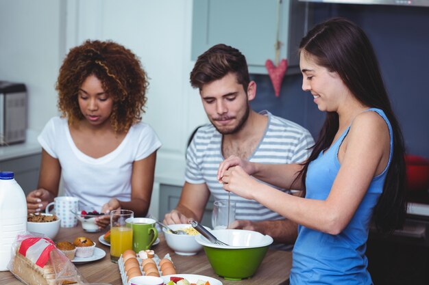 Sonrientes amigos en la mesa del desayuno