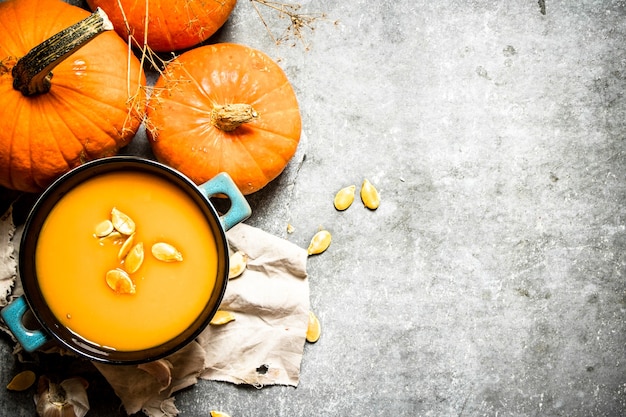 Sopa de calabaza de calabaza madura con semillas sobre la mesa de piedra