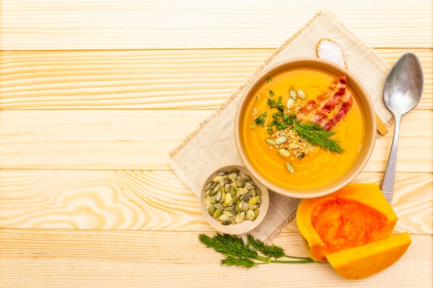 Foto sopa casera de crema de calabaza caliente de otoño con tocino ahumado y semillas