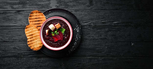 Sopa creme de beterraba em uma tigela com pão torrado comida dietética vista superior espaço para texto grátis