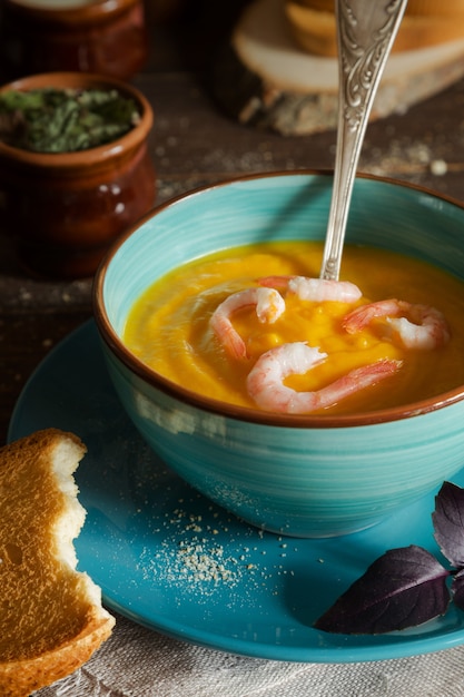 Foto sopa cremosa com camarão e torradas