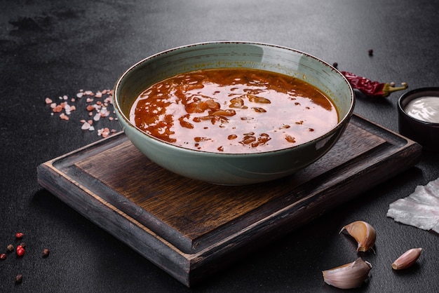 Sopa de beterraba quente fresca deliciosa com tomate e carne em um prato de cerâmica. sopa tradicional ucraniana