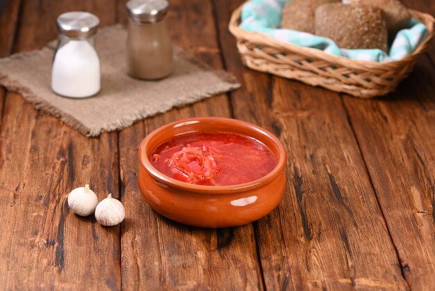 Foto sopa de beterraba vermelha russa com endro e creme de leite azedo em prato de barro