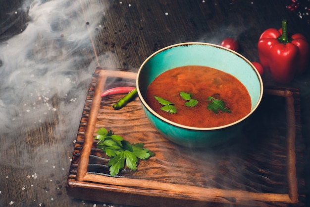 Foto sopa de kharcho con carne y arroz en la mesa de madera.