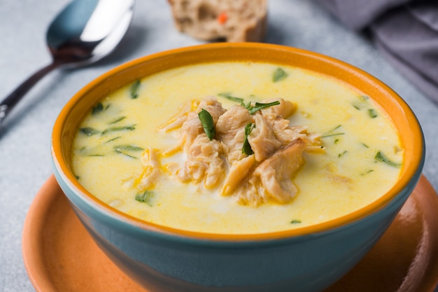 Foto sopa de salmón rosado con crema en un tazón de cerámica.