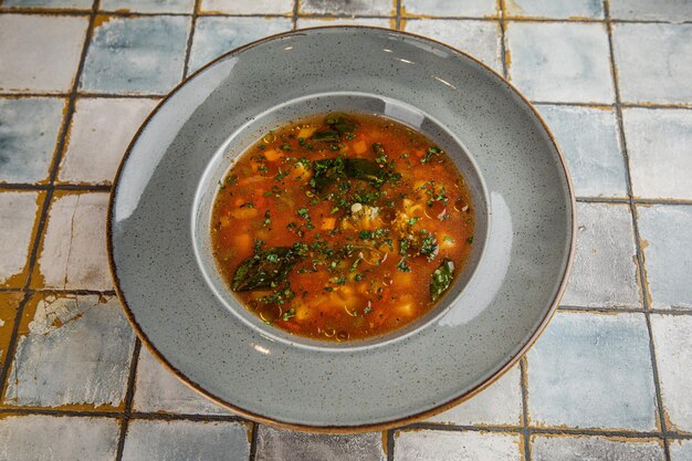 Sopa y tazón negro Sopa de pescado fresco en un tazón sobre fondo negro