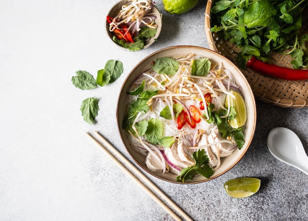 Foto sopa tradicional vietnamita - pho ga en un tazón con fideos de pollo y arroz