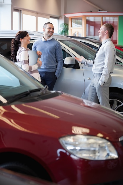 Sorridente vendedor conversando com clientes