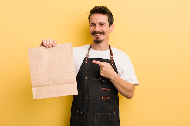 Sorrindo alegremente, sentindo-se feliz e apontando para o lado, o conceito de entrega de fast food