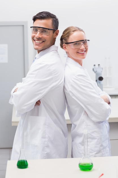 Sorrindo cientistas de pé de costas