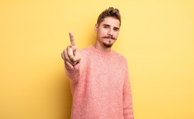 sorrindo com orgulho e confiança fazendo a pose número um sentindo-se como um líder triunfante