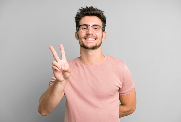 sorrindo e olhando feliz vitória despreocupada e gesticulando positivo ou paz com uma mão