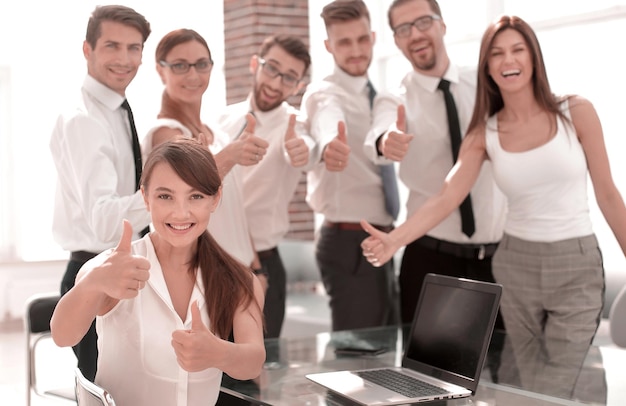 Sorrindo equipe de negócios mostrando polegares para cima