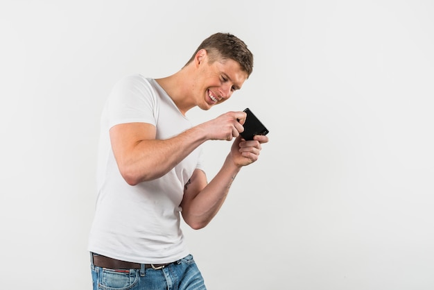 Sorrindo, homem jovem, videogame jogando, ligado, cellphone