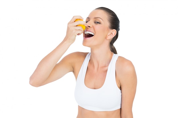 Sorrindo, mulher desportiva, bebendo suco de laranja