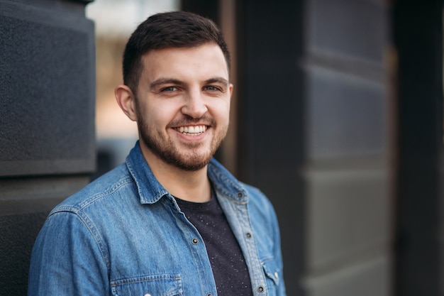 Foto sorriso de homem bonito. homem olha para o relógio