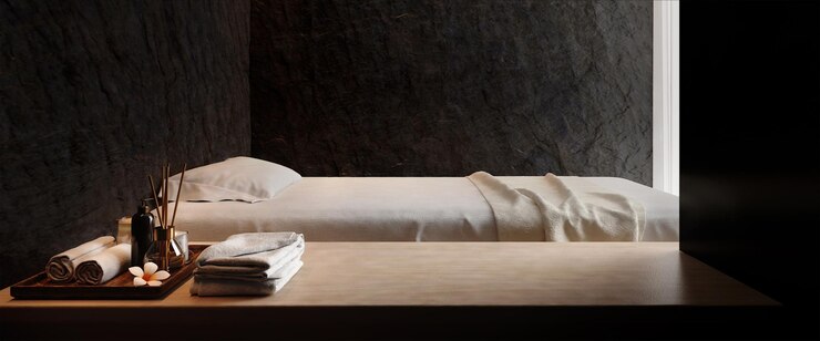 Spa y cama de masaje con fondo de pared de piedra oscura