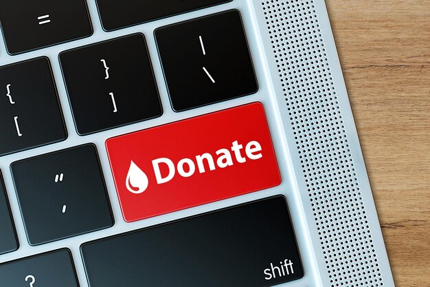 Spenden-Knopf auf der Computer-Tastatur Spenden- und Wohltätigkeitskonzept