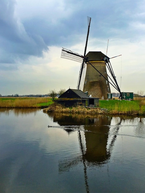 Foto spiegelung einer windmühle in einem ruhigen see