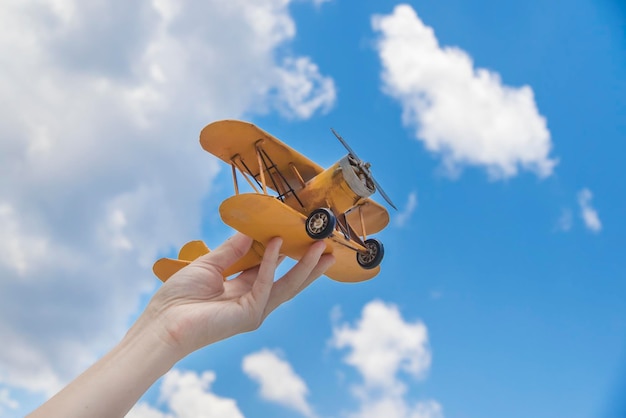 Spielzeugflugzeug in der Hand ein Symbol für Reisen und Träume