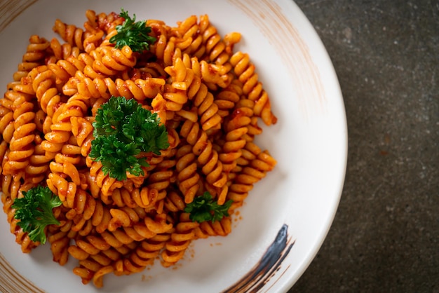 Spiral- oder Spirali-Nudeln mit Tomatensauce und Petersilie - italienische Küche