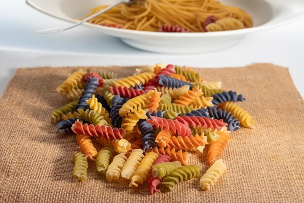 Foto spiral-pasta auf tischtuch und verschwommene spaghetti