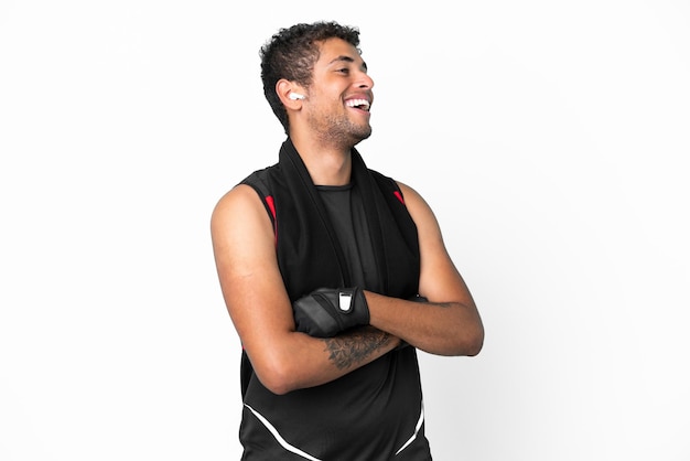 Sport brasilianischer Mann mit Handtuch isoliert auf weißem Hintergrund glücklich und lächelnd