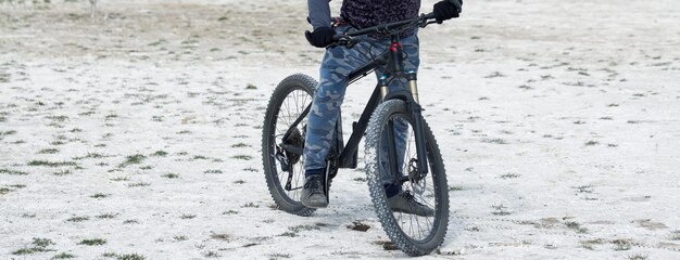 Sport brutaler bärtiger Kerl auf einem modernen Mountainbike Ein Radfahrer an einem salzwüsten Ort am See