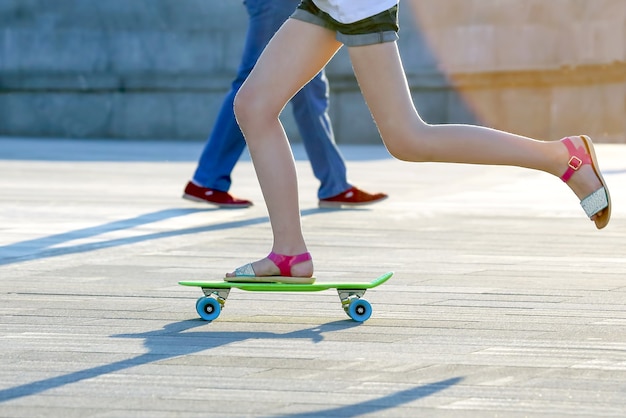 Sport- und Freizeitjugendliche im Urlaub. Füße Mädchen Skateboarden in der Stadt.