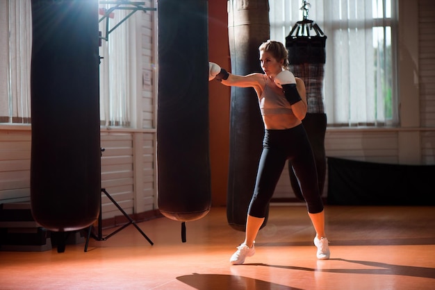 Foto sportliches mädchen macht boxübungen im fitnessstudio